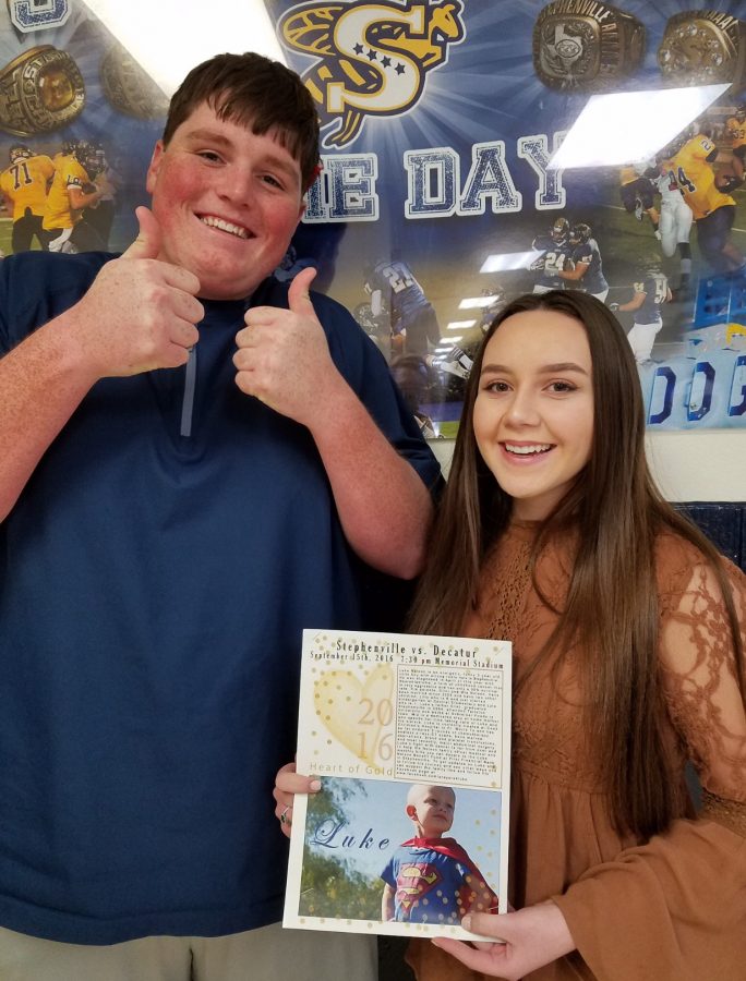  Emily Moore and Caleb Gibbons holding their inspiration.