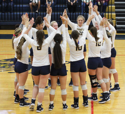 The 2018 Honeybees gather in the center of the court following tradition in order to prepare themselves for a home game during their fall season. 
