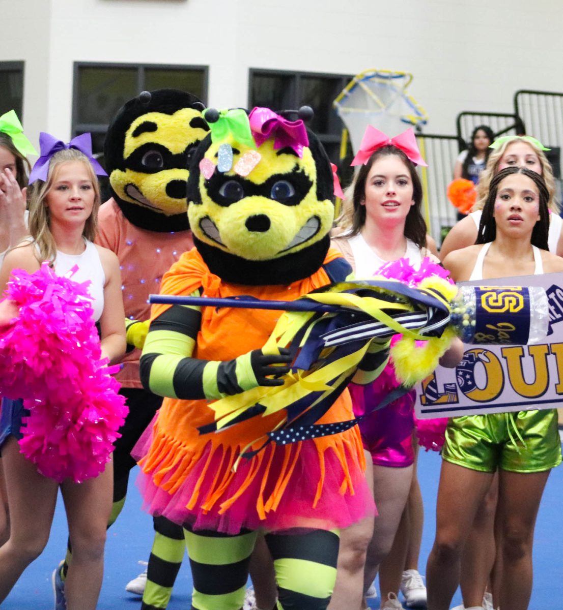 Bumble and Buzz help out the cheerleaders with school spirit at the neon Pep Rally.